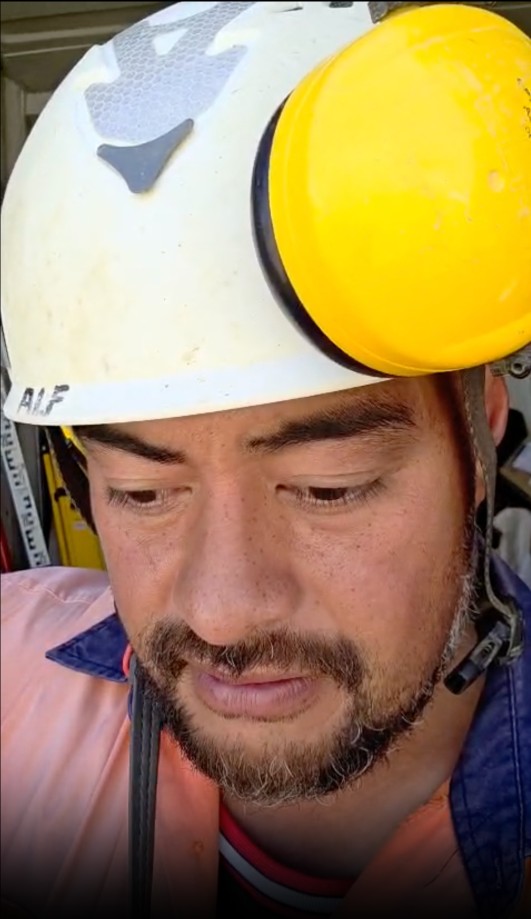 Alfred on a building site in his hard hat and hi-vis